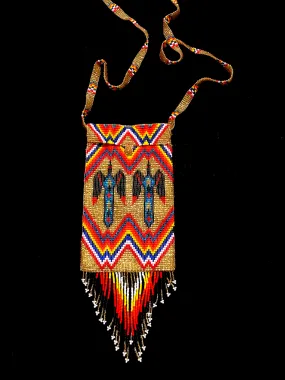 Guatemalan handcrafted glass bead shoulder bag, approximately 4” x 7” with a 32 inch strap. The bags are decorated on both sides